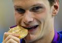 1037429_france-s-yannick-agnel-bites-his-gold-medal-after-w.jpg