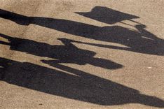 458097-a-schoolchild-casts-his-shadows-as-he-holds-hands-of