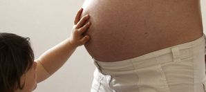 867092_a-child-touches-her-pregnant-mother-s-stomach-at-the.jpg