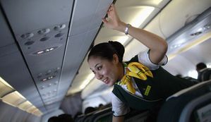 crew-member-of-spring-airlines-talks-with-travelers-onboard.jpg