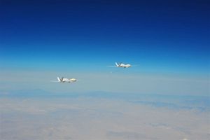2 Global Hawk Unmanned Aircraft Fly in Close Formation
