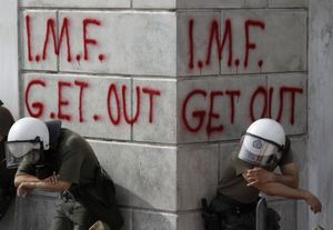 482516_greek-riot-policemen-rest-in-front-of-graffiti-durin.jpg