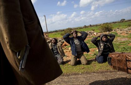 Anti-Qaddafi-militia-stop-3-Black-Africans-at-checkpoint-Li
