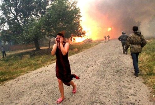 538423_a-woman-reacts-while-heavy-smoke-emits-and-fire-burn.jpg